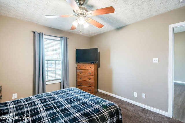 bedroom featuring a textured ceiling, dark carpet, a ceiling fan, and baseboards