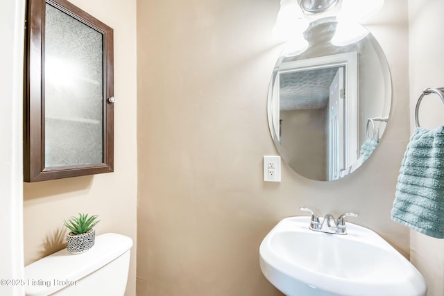 bathroom featuring a sink and toilet