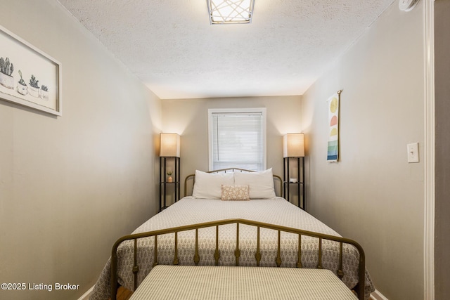 bedroom featuring baseboards and a textured ceiling