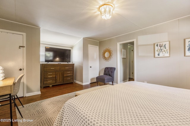 bedroom featuring dark wood finished floors and baseboards