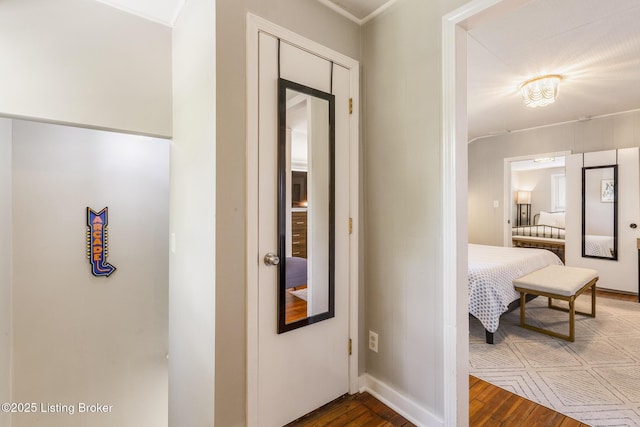 hallway with wood finished floors and baseboards