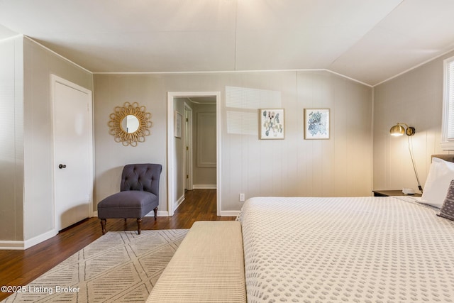 bedroom with lofted ceiling, baseboards, and wood finished floors