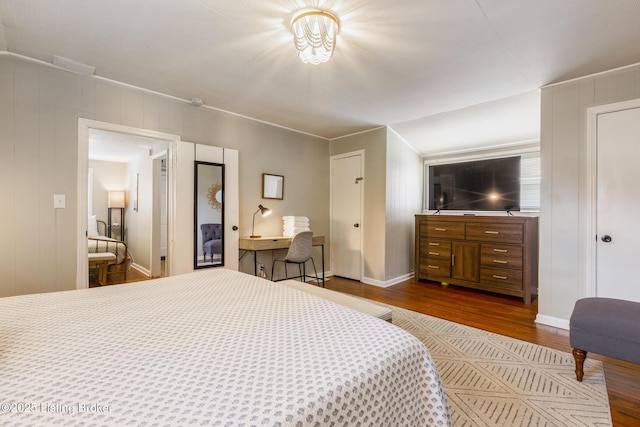 bedroom with dark wood-style floors and baseboards