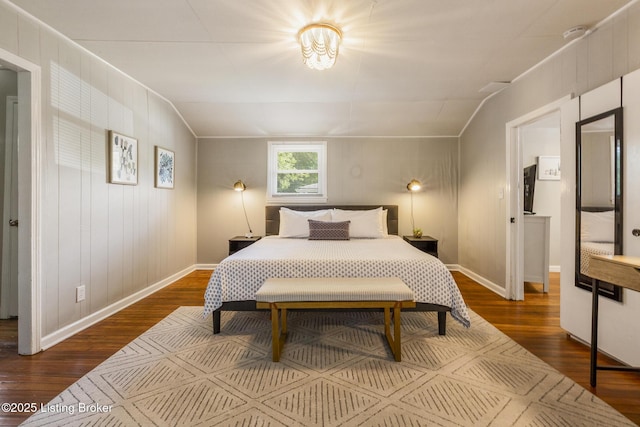 bedroom with lofted ceiling, dark wood-style floors, and baseboards