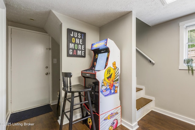 interior space with baseboards, a textured ceiling, stairway, and wood finished floors