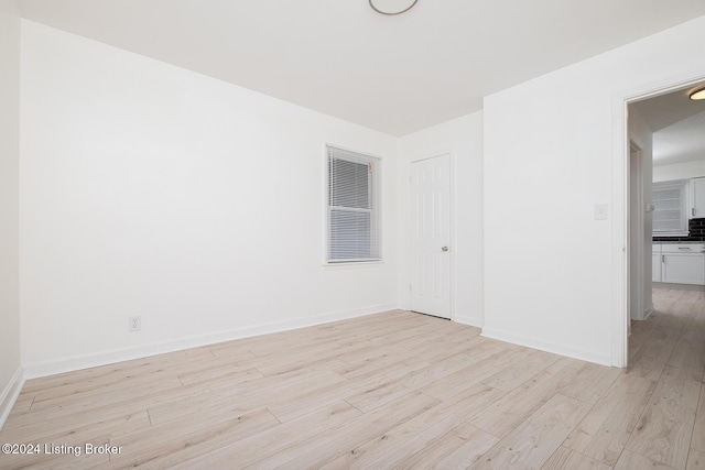 empty room featuring light wood-style floors and baseboards