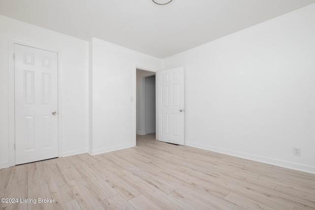 unfurnished bedroom featuring baseboards and wood finished floors