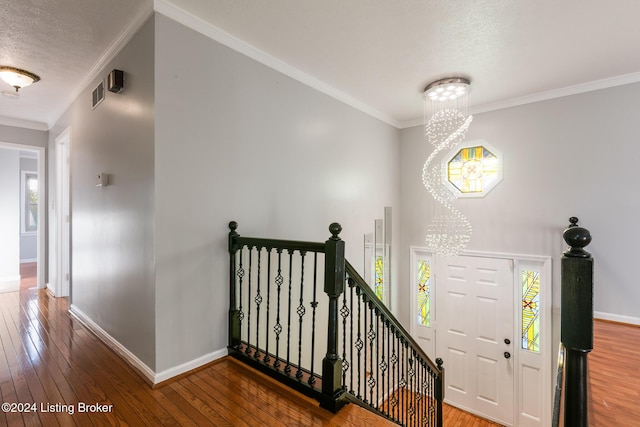 interior space featuring hardwood / wood-style flooring, baseboards, and ornamental molding