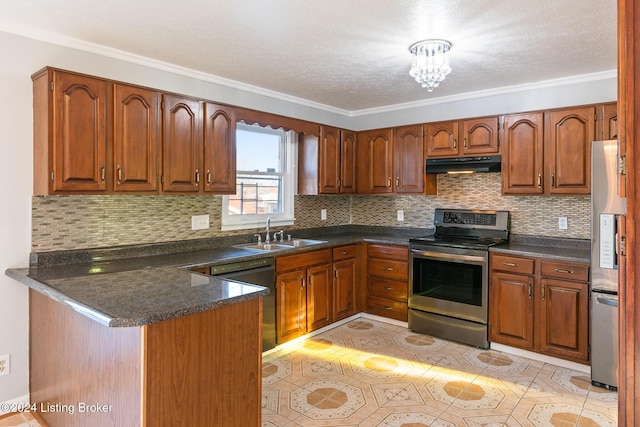 kitchen with dark countertops, under cabinet range hood, stainless steel appliances, and a sink