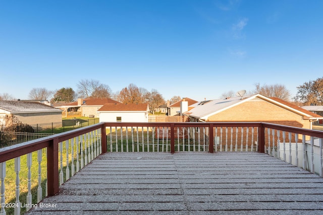 wooden deck with a fenced backyard and a residential view