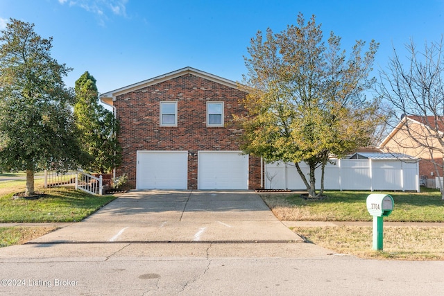 view of front of house with brick siding, fence, driveway, and a front lawn