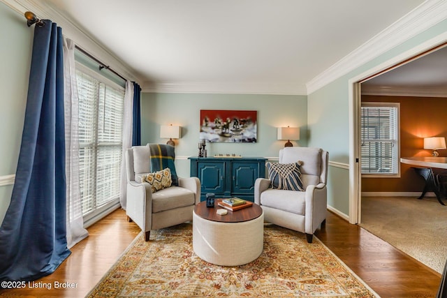 sitting room featuring ornamental molding, wood finished floors, and baseboards