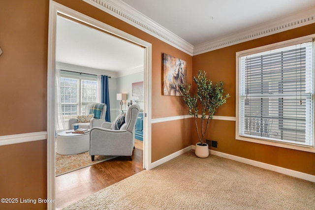 hallway featuring visible vents, baseboards, crown molding, and wood finished floors