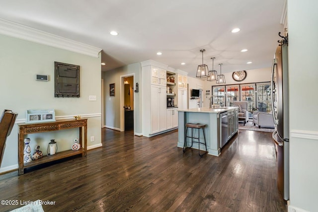 kitchen featuring a breakfast bar area, recessed lighting, dark wood-style flooring, white cabinetry, and appliances with stainless steel finishes