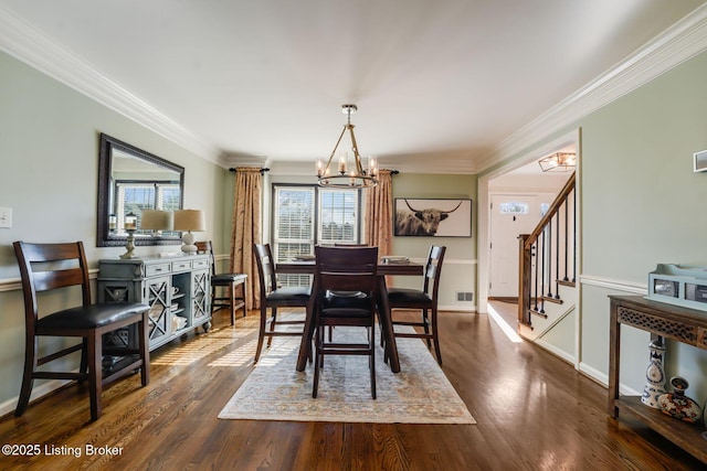 dining space featuring a notable chandelier, baseboards, ornamental molding, stairway, and dark wood finished floors