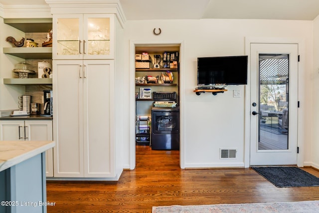 interior space featuring dark wood-style floors, baseboards, and visible vents