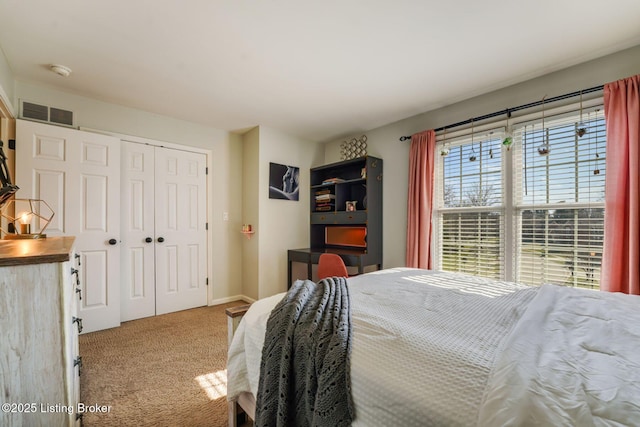 bedroom featuring a closet, visible vents, and carpet flooring