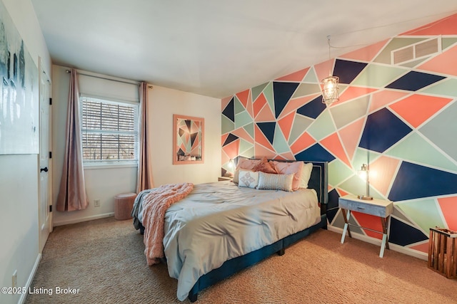 bedroom featuring carpet floors, visible vents, an accent wall, and baseboards