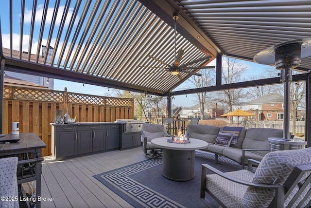 wooden deck featuring a grill, an outdoor living space, and a ceiling fan