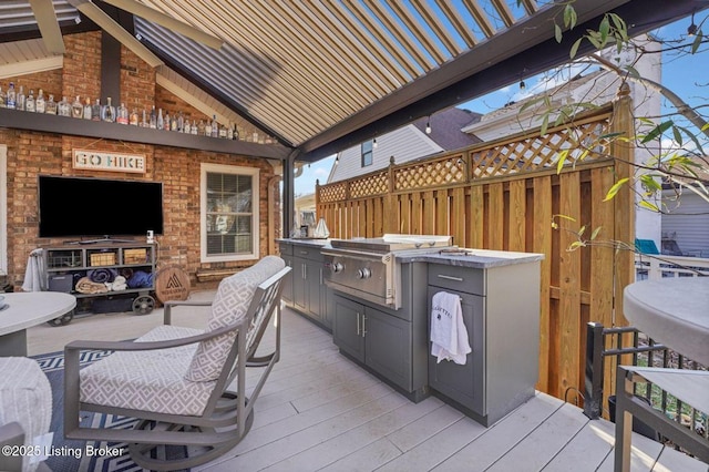 view of patio / terrace with a deck, a fireplace, and grilling area