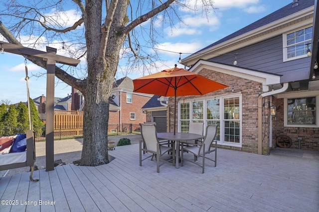 deck with fence and outdoor dining area