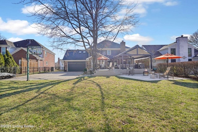 back of house with a residential view, fence, and a yard