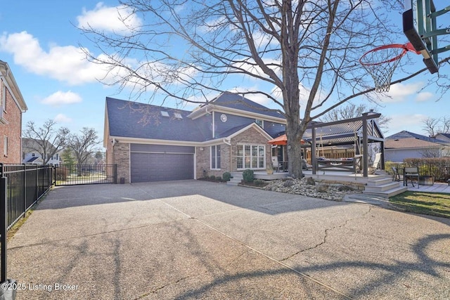 view of front of home featuring brick siding, concrete driveway, a gazebo, an attached garage, and fence