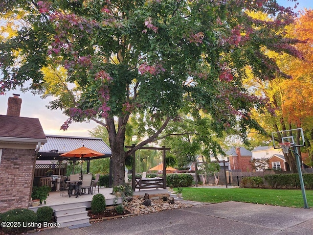 view of home's community featuring a yard, fence, and a wooden deck