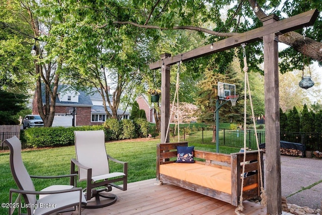 wooden deck featuring a lawn and fence