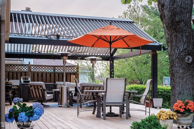 wooden deck with a pergola and outdoor dining space