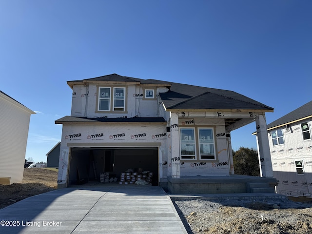 unfinished property with driveway and an attached garage