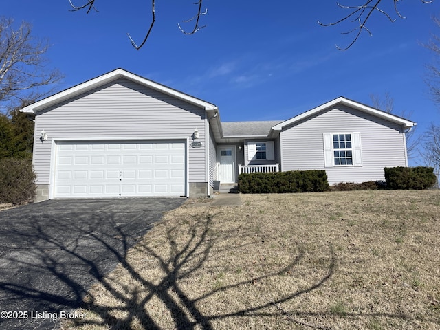 ranch-style house featuring an attached garage and aphalt driveway