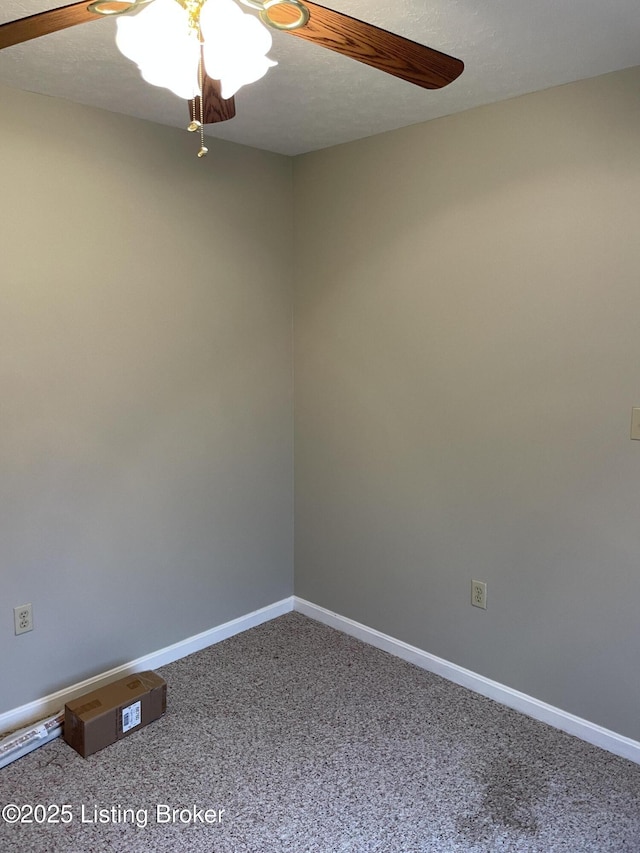 spare room with carpet floors, a textured ceiling, baseboards, and a ceiling fan