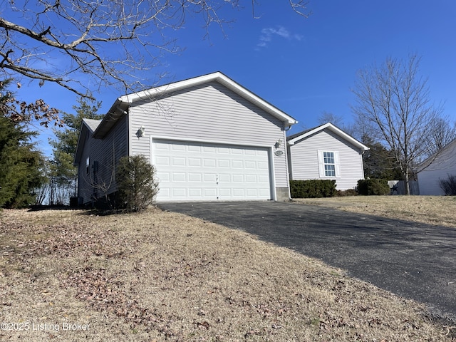 view of home's exterior featuring an attached garage and driveway