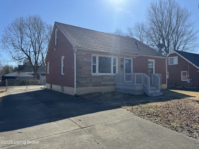 view of front of home with a shingled roof and fence