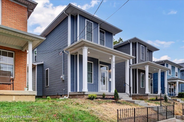 view of front of home with fence and board and batten siding