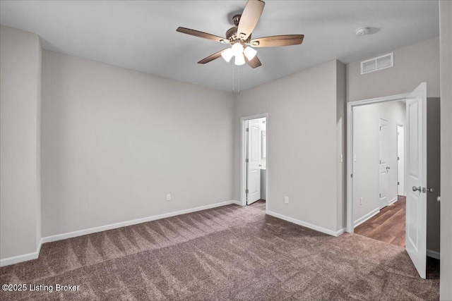 unfurnished bedroom featuring ceiling fan, carpet flooring, visible vents, and baseboards