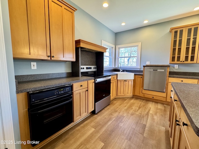 kitchen with dark countertops, stainless steel appliances, and a sink