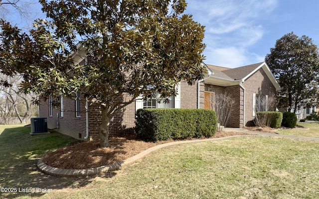 view of home's exterior featuring central air condition unit, a yard, and brick siding