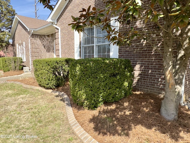 view of home's exterior with brick siding