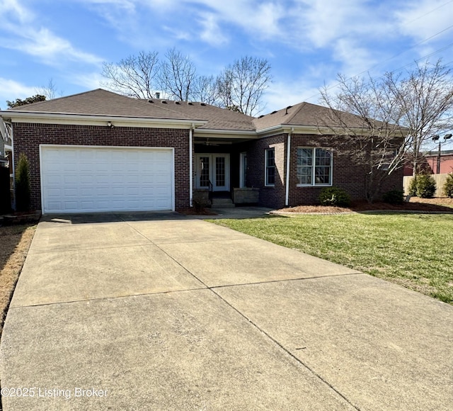 ranch-style home with a shingled roof, concrete driveway, an attached garage, a front yard, and brick siding