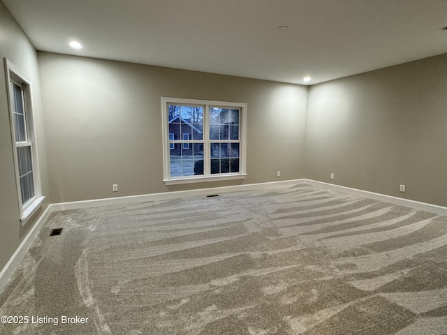 carpeted empty room with recessed lighting, baseboards, and visible vents