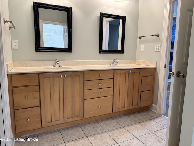 full bath with tile patterned flooring, double vanity, and a sink