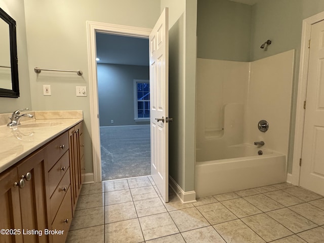 bathroom featuring tub / shower combination, baseboards, vanity, and tile patterned flooring