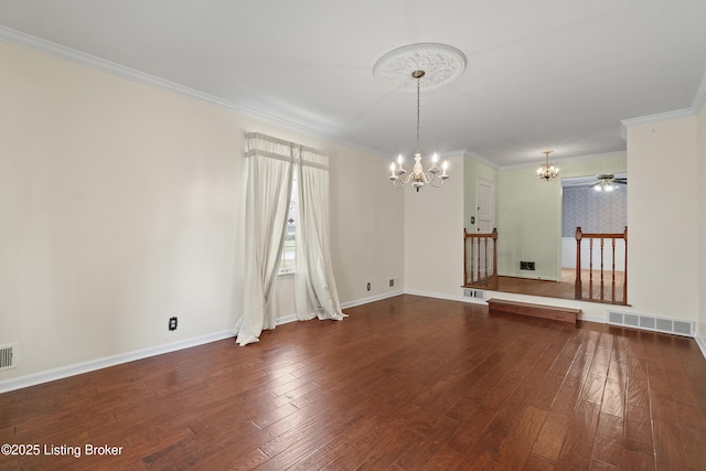 unfurnished room with hardwood / wood-style flooring, crown molding, baseboards, and visible vents