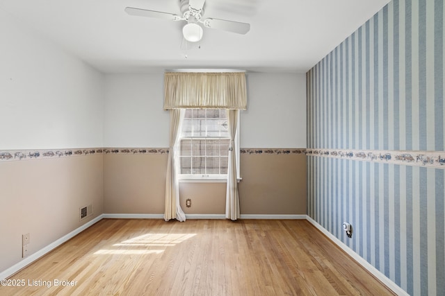 3004 Brownsboro Vista Dr, Louisville, KY 40242 - empty room featuring visible vents, wood finished floors, wallpapered walls, baseboards, and an accent wall