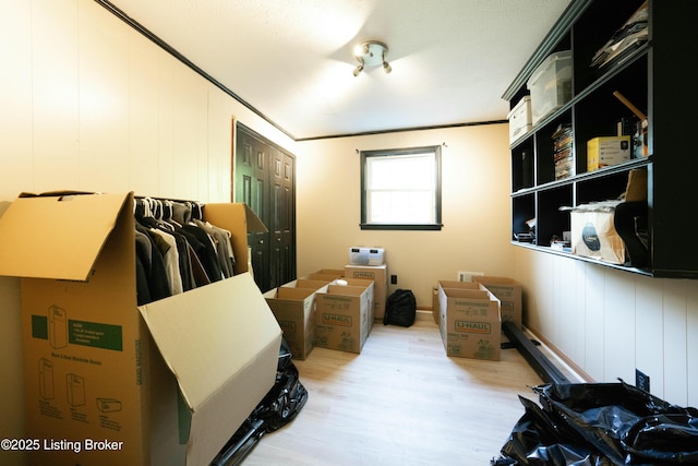 bedroom with crown molding, a closet, and wood finished floors