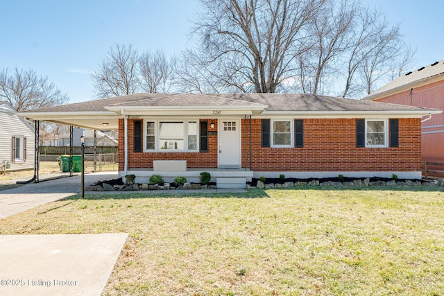 view of front of home featuring brick siding, concrete driveway, fence, a carport, and a front lawn