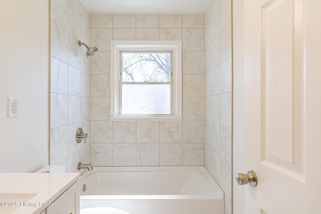 bathroom featuring  shower combination, vanity, and toilet