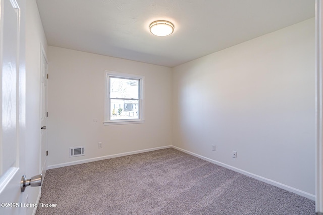 unfurnished room with carpet floors, baseboards, and visible vents